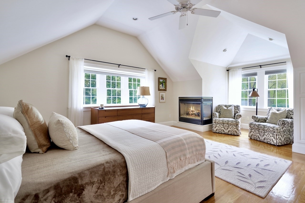 86 Allen Farm Lane Concord, MA 01742 - Photo 17 of 34 a spacious bedroom with a bed and a couch