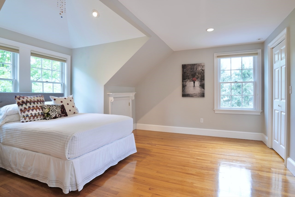 86 Allen Farm Lane Concord, MA 01742 - Photo 22 of 34 a bedroom with a large bed and wooden floor