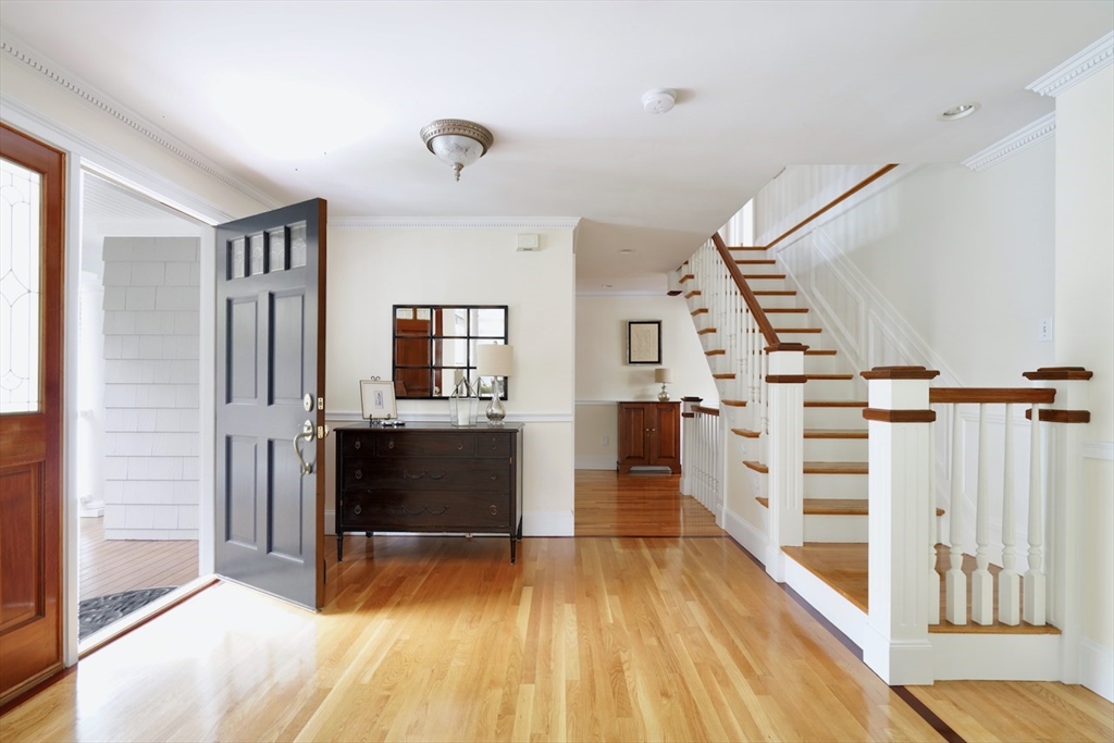 86 Allen Farm Lane Concord, MA 01742 - Photo 3 of 34 a view of a hallway with wooden floor and staircase