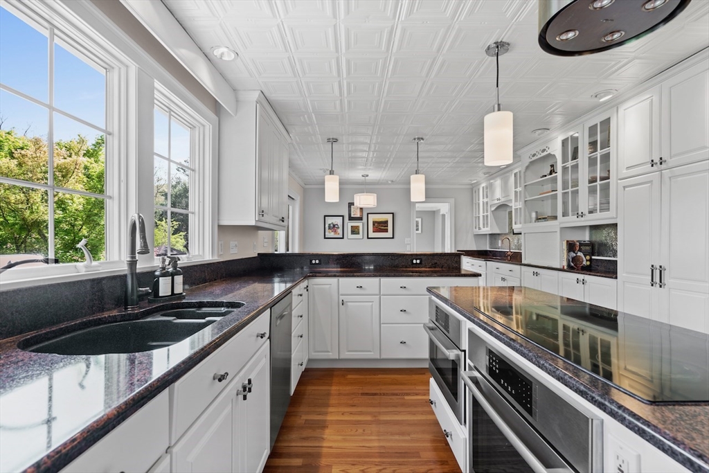 86 Allen Farm Lane Concord, MA 01742 - Photo 10 of 34 a kitchen with stainless steel appliances a sink a stove and cabinets