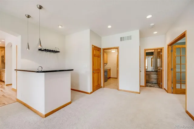 a bathroom with a granite countertop sink a toilet and a bathtub