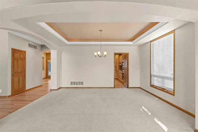 a kitchen with stainless steel appliances granite countertop a sink a stove and a wooden floors