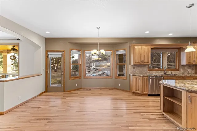 a view of an empty room with a kitchen