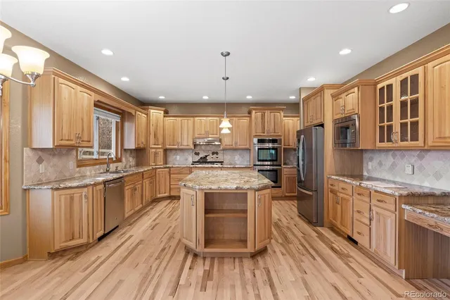 a view of an empty room with kitchen