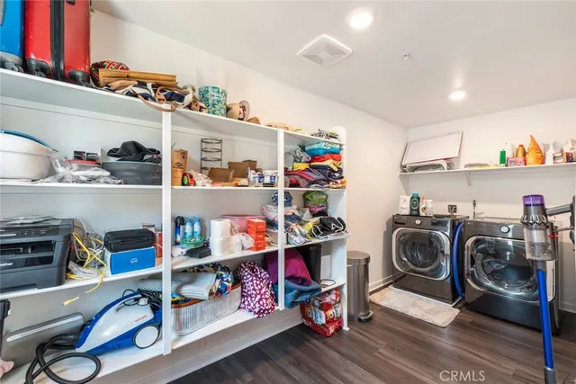 a utility room with lots of clutter and refrigerator