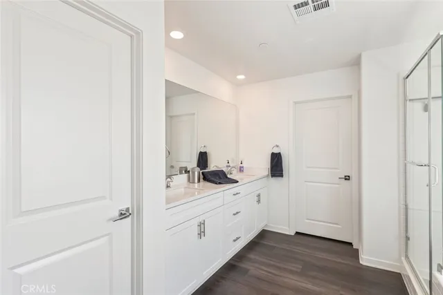 a bathroom with a double vanity sink and mirror