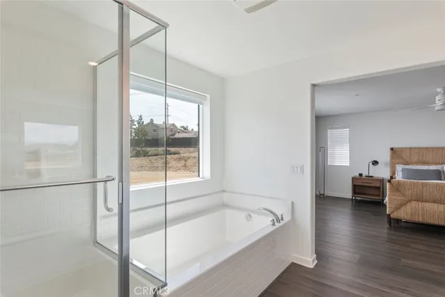 a bathroom with a tub and view of bathroom