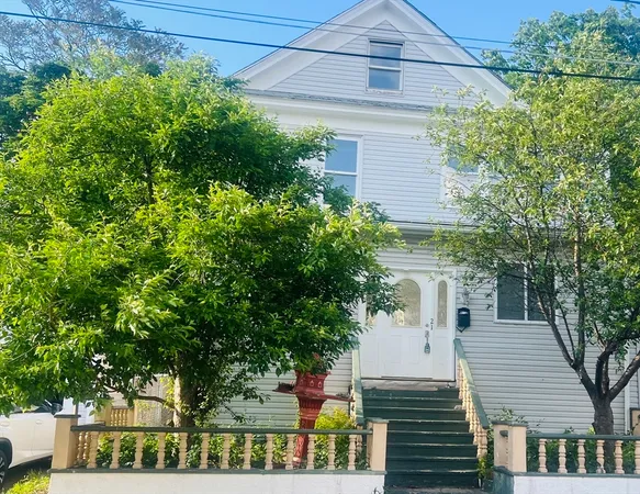 a view of a house with a tree