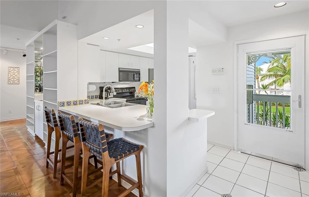433 2nd Street South, Unit B202 Naples, FL 34102 - Photo 14 of 31 a view of a dining room with furniture and a window