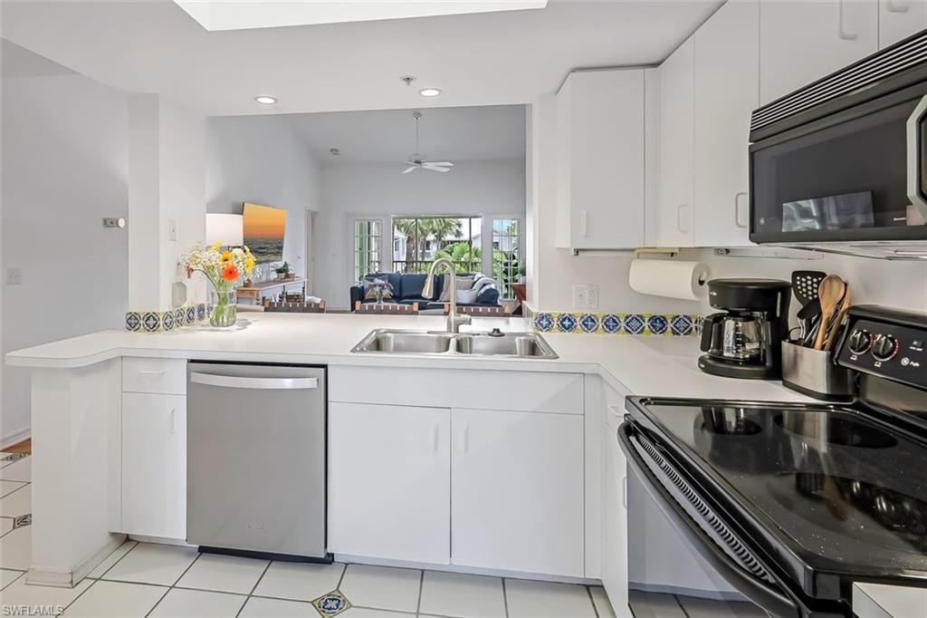 433 2nd Street South, Unit B202 Naples, FL 34102 - Photo 15 of 31 a kitchen with appliances a sink and cabinets