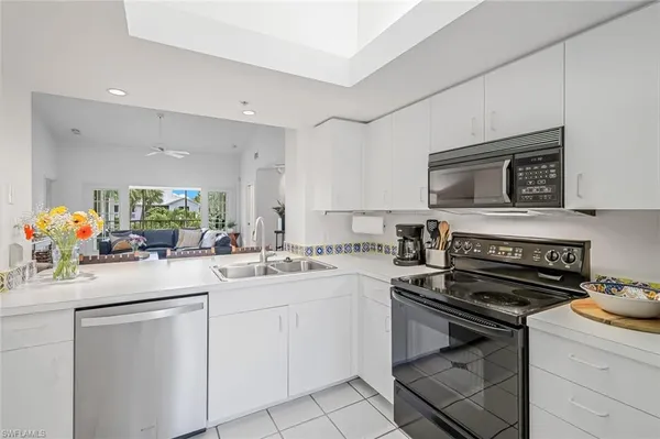 a kitchen with a sink stove and microwave