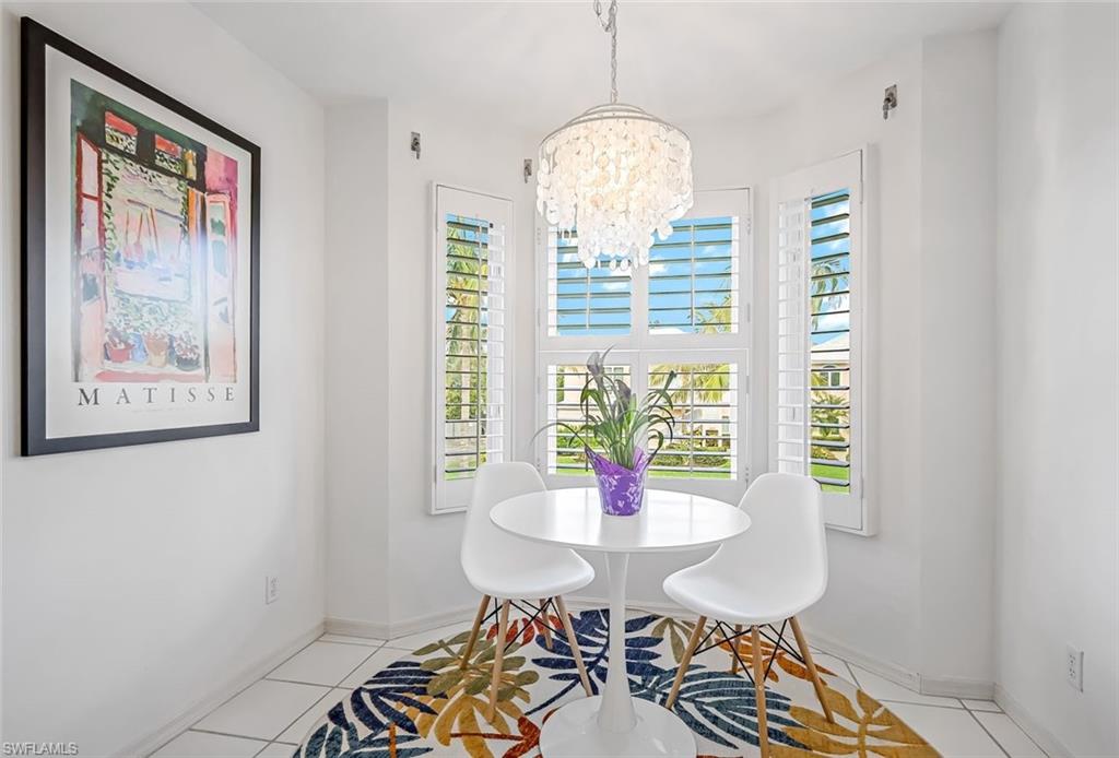 433 2nd Street South, Unit B202 Naples, FL 34102 - Photo 18 of 31 a view of a dining room with furniture window and wooden floor