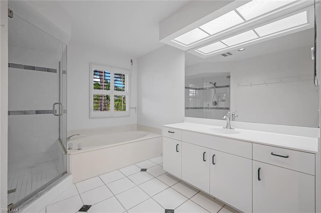 433 2nd Street South, Unit B202 Naples, FL 34102 - Photo 21 of 31 a bathroom with a sink a toilet and shower