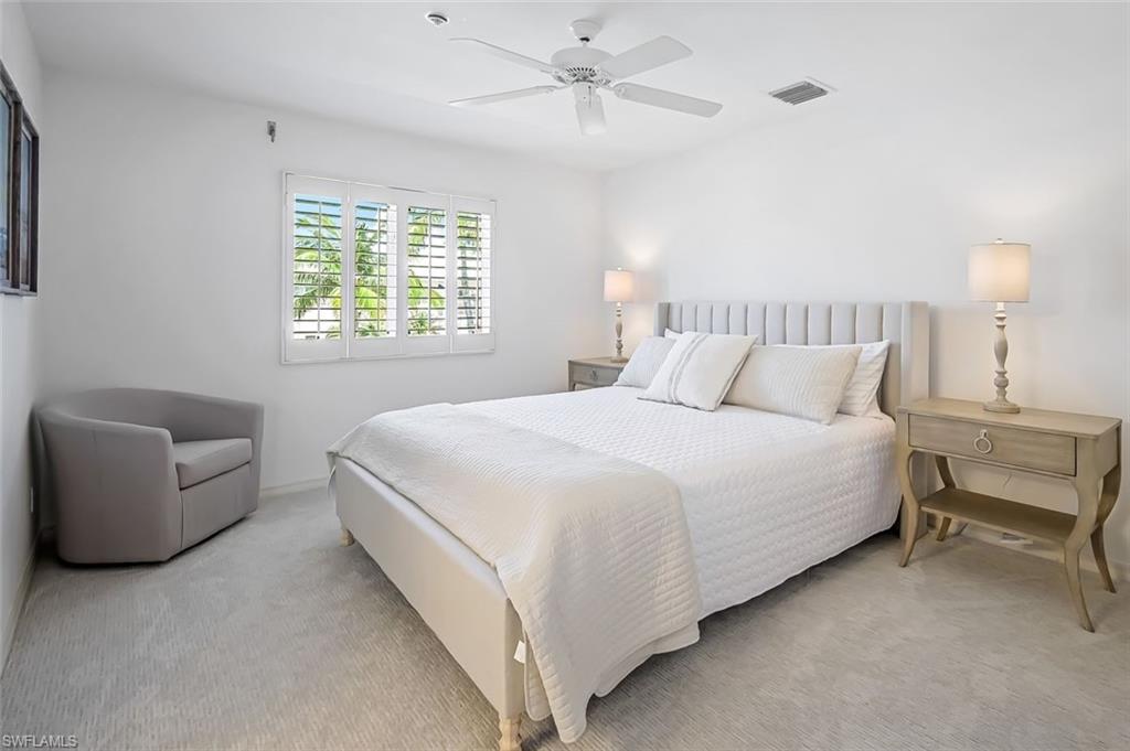 433 2nd Street South, Unit B202 Naples, FL 34102 - Photo 23 of 31 a bedroom with a bed and a couch