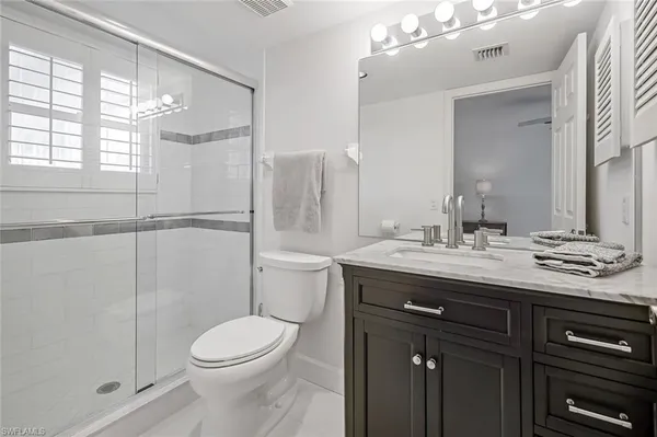a bathroom with a toilet a sink and shower