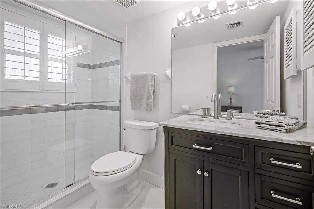 433 2nd Street South, Unit B202 Naples, FL 34102 - Photo 24 of 31 a bathroom with a toilet a sink and shower