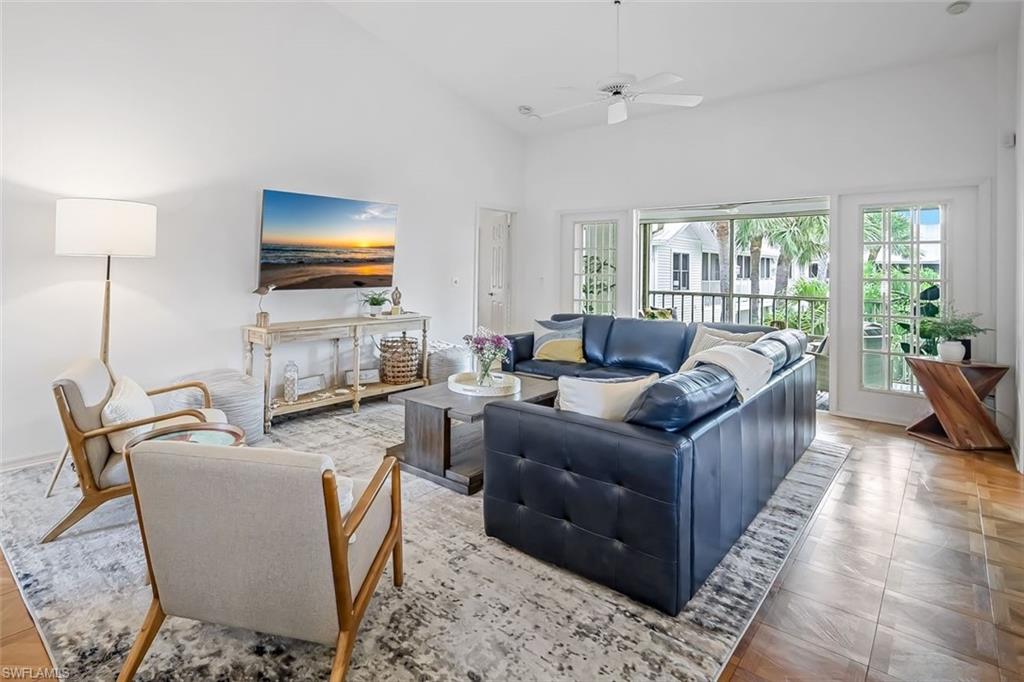 433 2nd Street South, Unit B202 Naples, FL 34102 - Photo 6 of 31 a living room with furniture and a flat screen tv