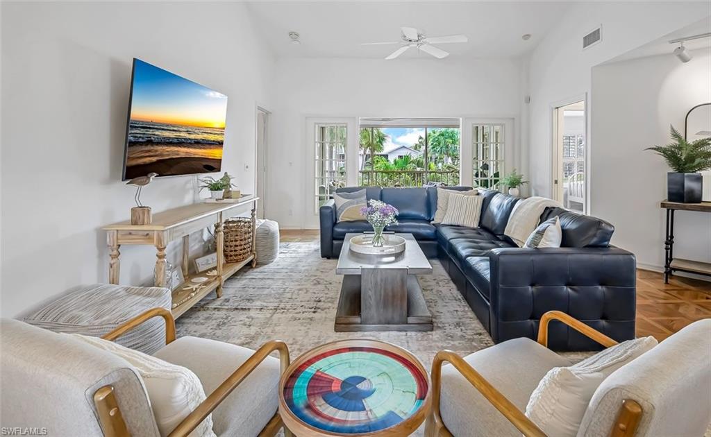 433 2nd Street South, Unit B202 Naples, FL 34102 - Photo 7 of 31 a living room with furniture and a flat screen tv