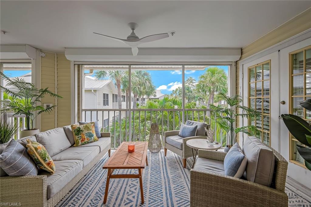 433 2nd Street South, Unit B202 Naples, FL 34102 - Photo 9 of 31 a living room with furniture and a floor to ceiling window