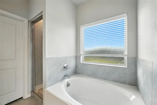 a bathroom with a bathtub and a shower