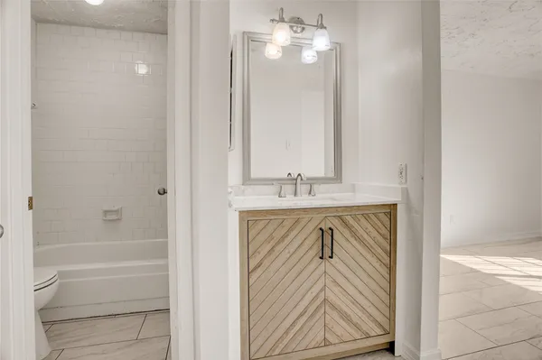 a bathroom with a shower and a sink