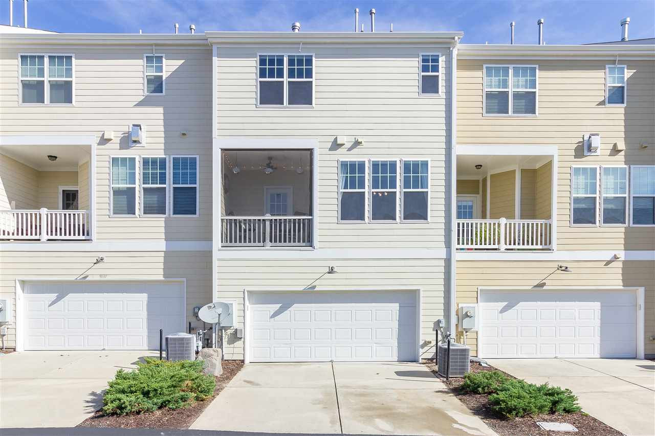 9135 Falkwood Road Raleigh, NC 27617 - Photo 25 of 25 A view of the back of the home showing the flat driveway and screened porch. A private neighborhood road leads to the driveway so no through traffic behind this home!