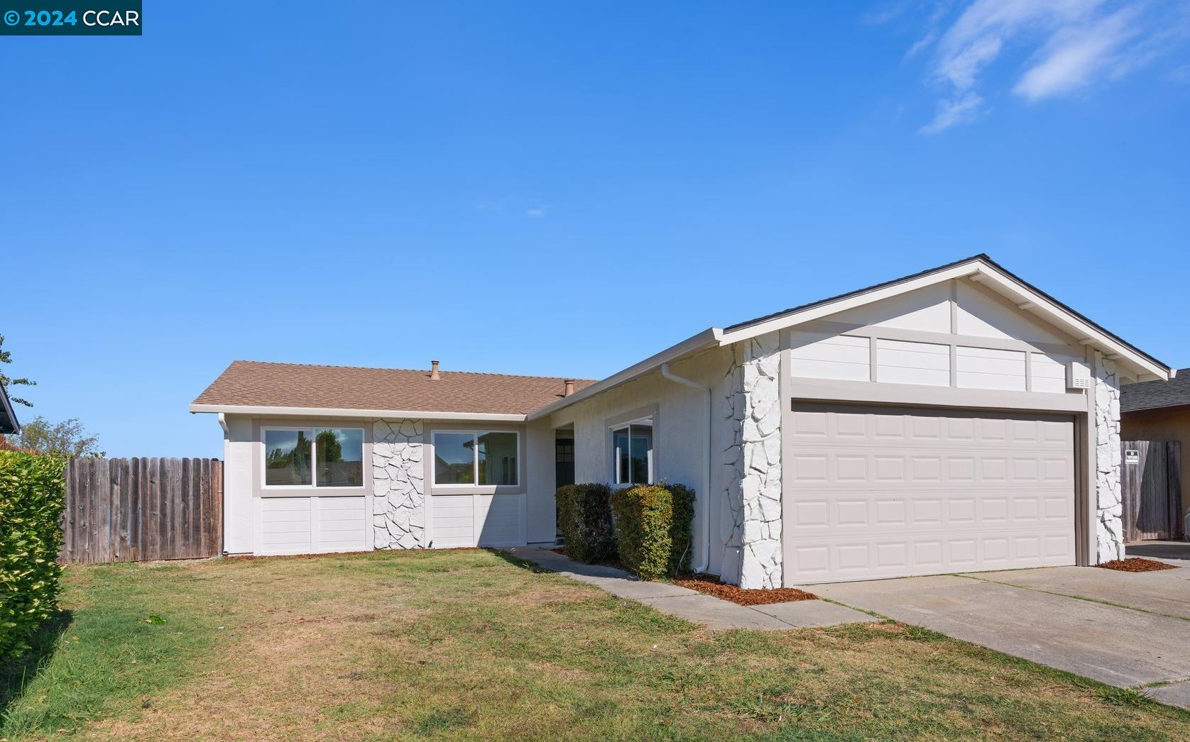 a view of a house with a yard and garage