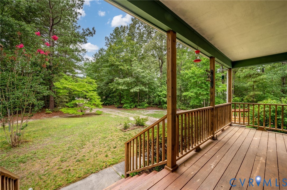 Expansive covered porch featuring wood flooring an