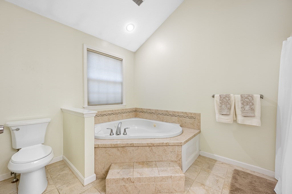 22 Mashapaug Road Sturbridge, MA 01566 - Photo 25 of 34 a bathroom with a bathtub and a toilet
