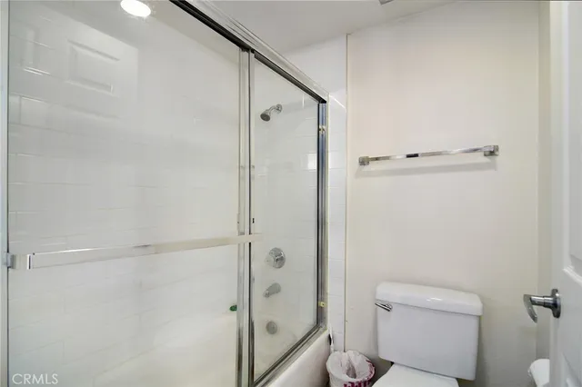 a bathroom with a shower and a toilet