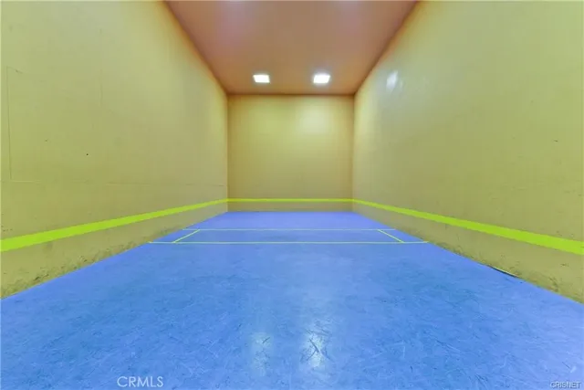 a view of a room with wooden floor and a window