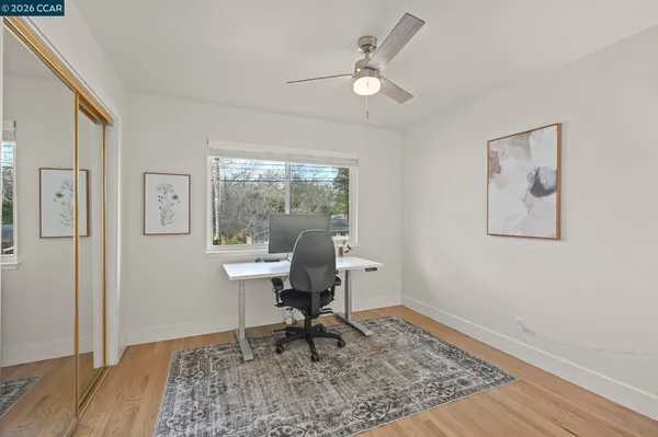 a workspace with wooden floor and a window