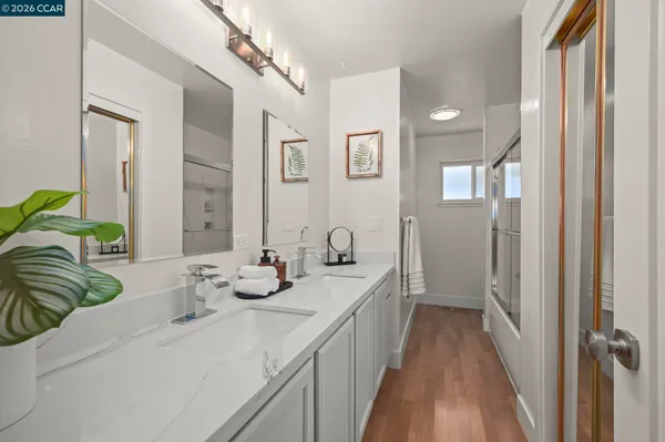 a bathroom with double vanity and a mirror