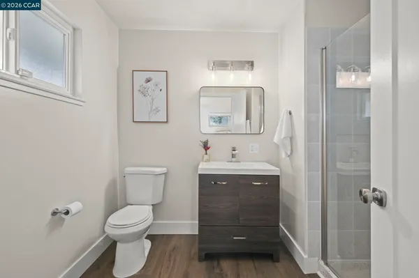 a bathroom with a toilet sink vanity and mirror