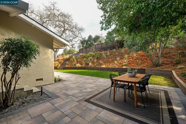 a patio with table and chairs