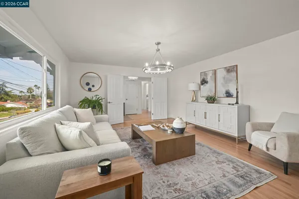 a living room with furniture rug and window