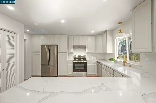 a kitchen with a refrigerator and a sink