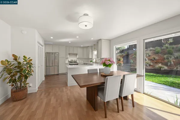 a view of a dining room with furniture and a potted plant