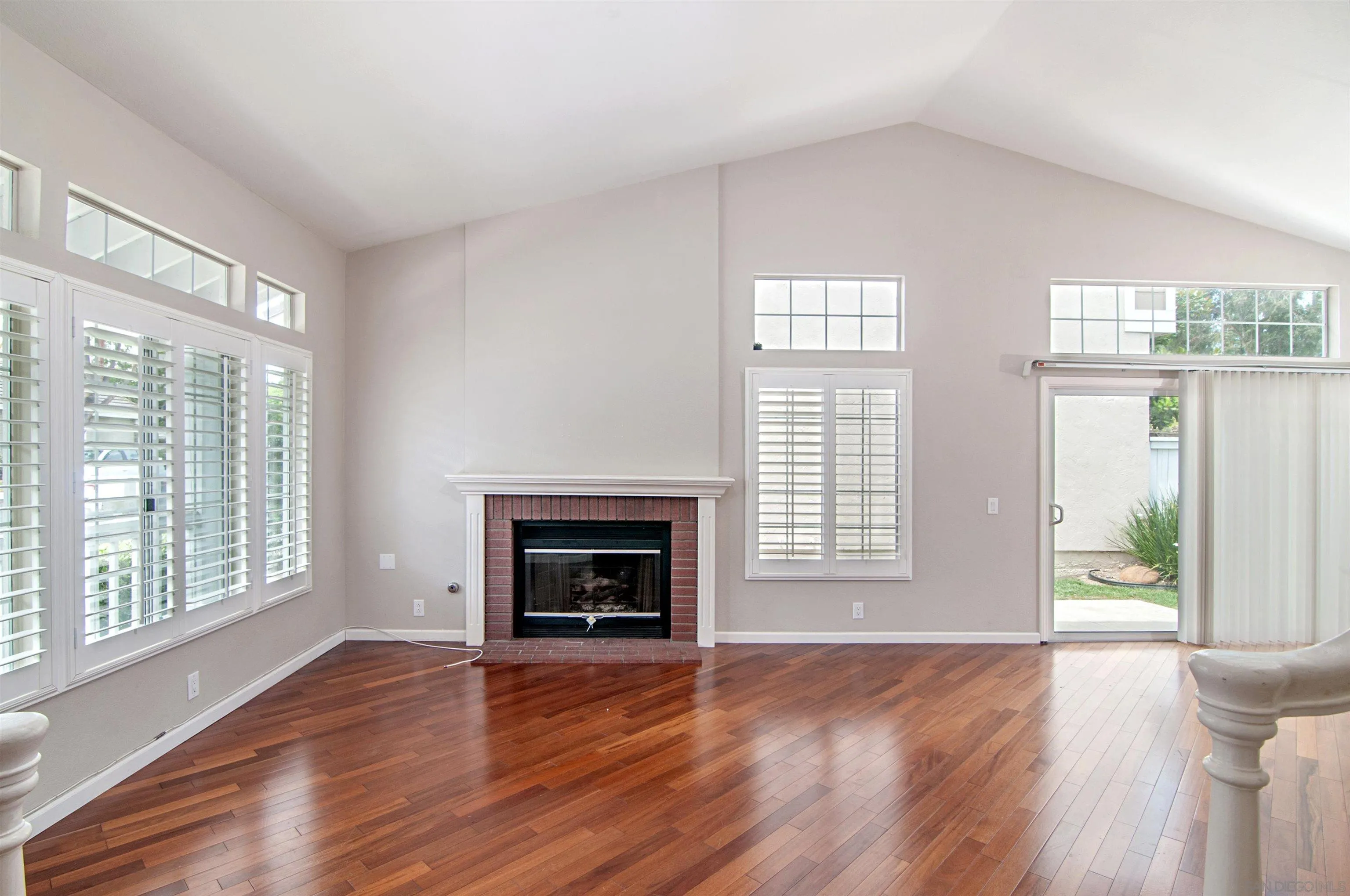 14530 Rutledge Square San Diego, CA 92128 - Photo 2 of 4 a view of an empty room with wooden floor and a window