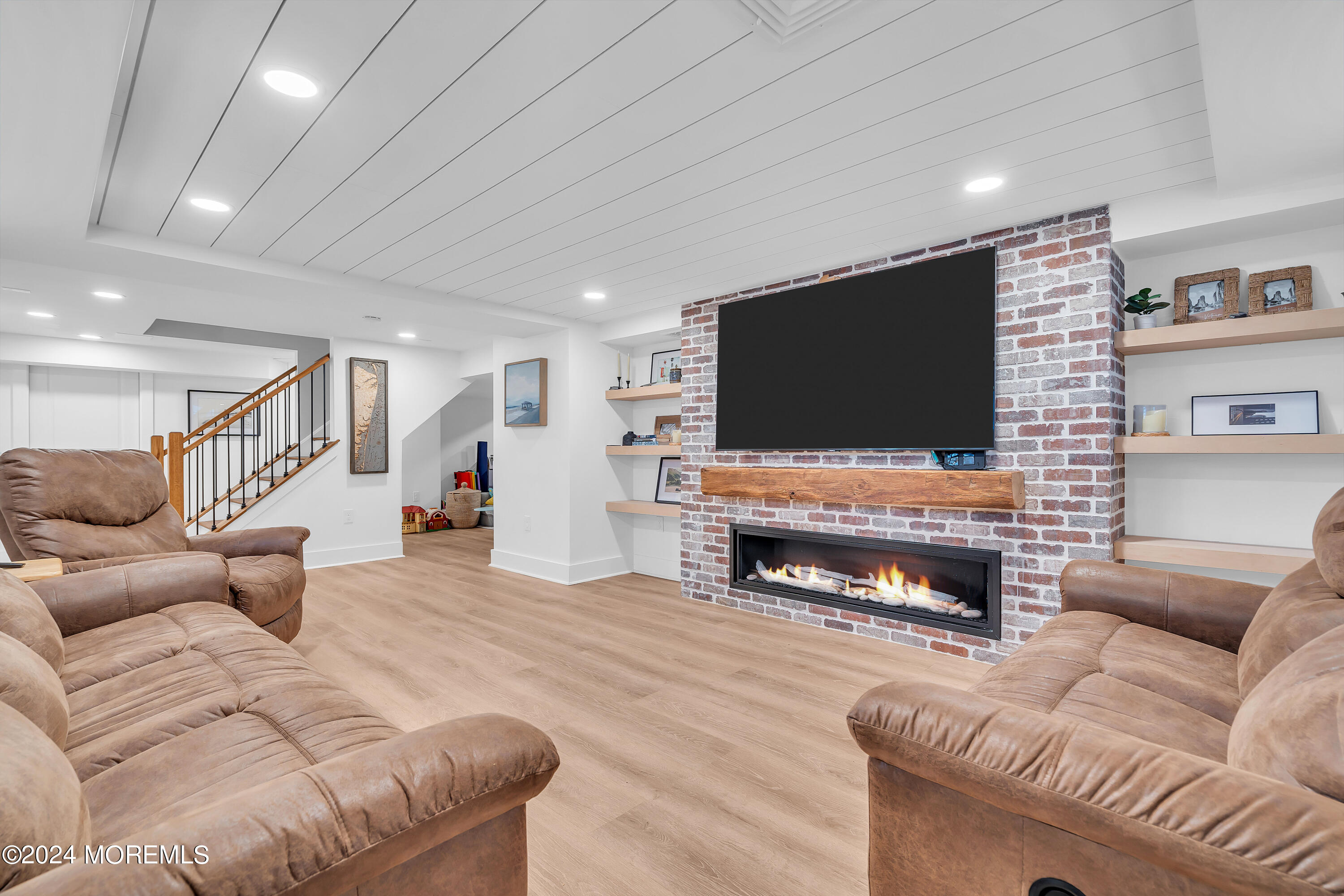 1120 Mohegan Road Manasquan, NJ 08736 - Photo 32 of 38 a living room with furniture and a flat screen tv