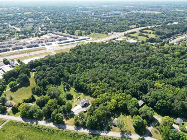 an aerial view of residential houses with outdoor space and swimming pool