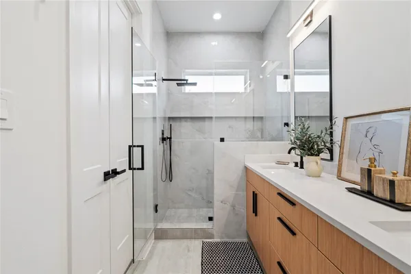 a bathroom with a tub sink and mirror