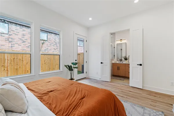 a bedroom with a bed and a large window