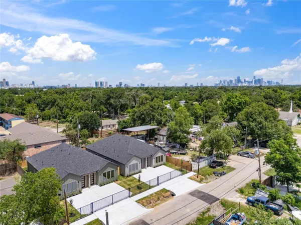 an aerial view of a house with a yard and lake view in back