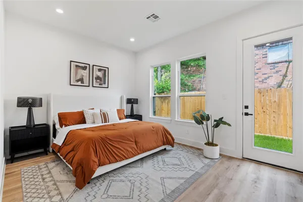 a bedroom with a bed and a painting on the wall