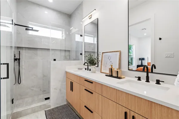 a bathroom with a shower sink and mirror