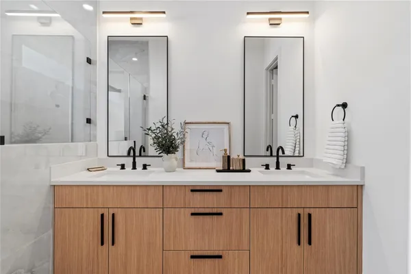 a bathroom with a double vanity sink and mirror
