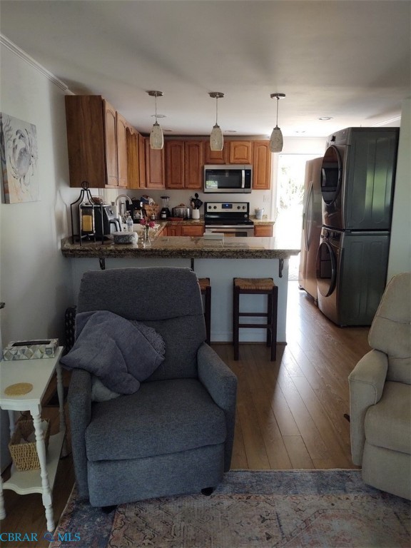 777 Marsh Pungo Road Locust Hill, VA 23092 - Photo 25 of 46 Living room with dark wood-style floors and stacked washer and clothes dryer