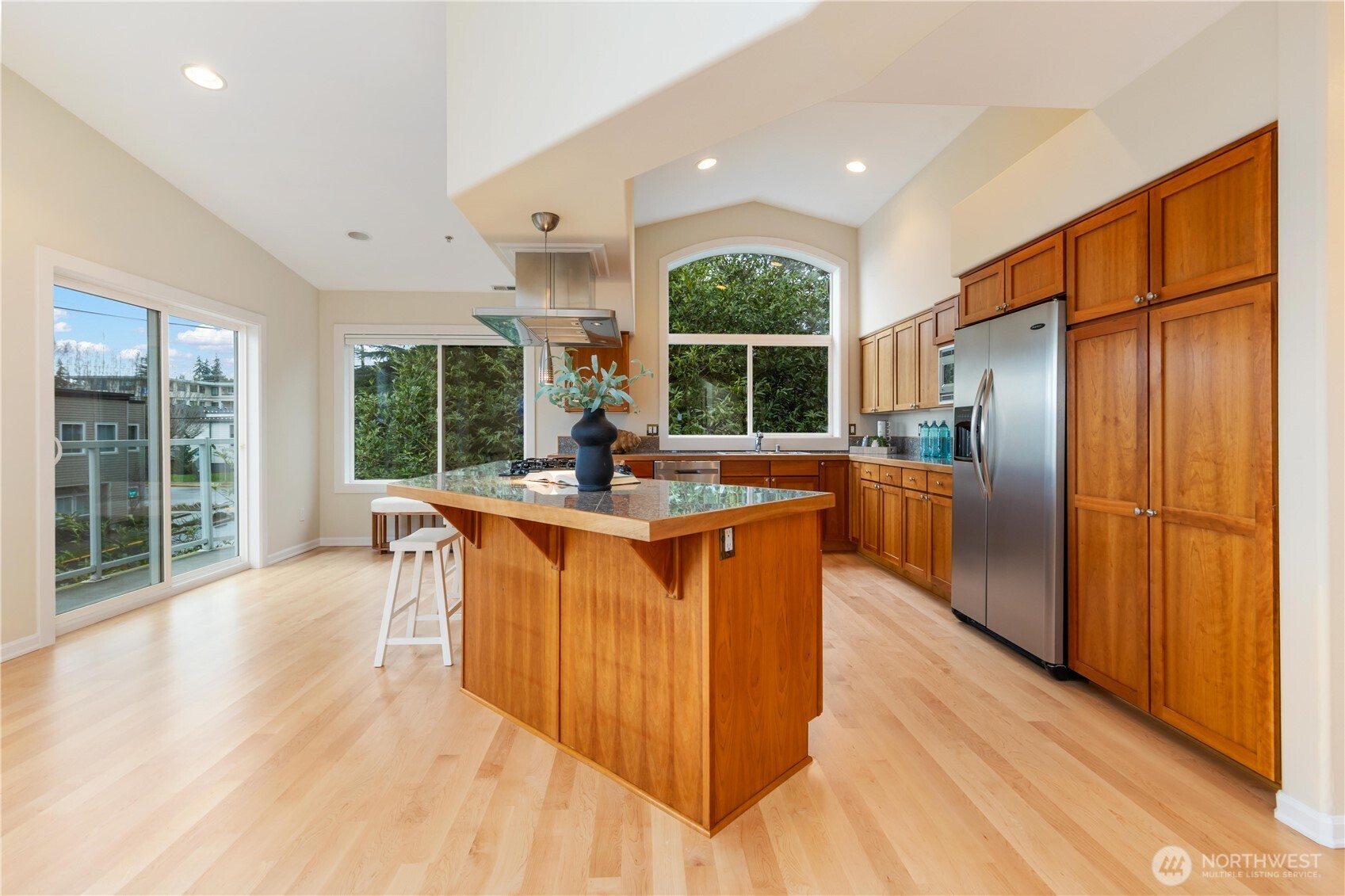 550 Dayton Street, Unit 201 Edmonds, WA 98020 - Photo 16 of 38 a kitchen with stainless steel appliances granite countertop a refrigerator a sink a stove and a wooden floors
