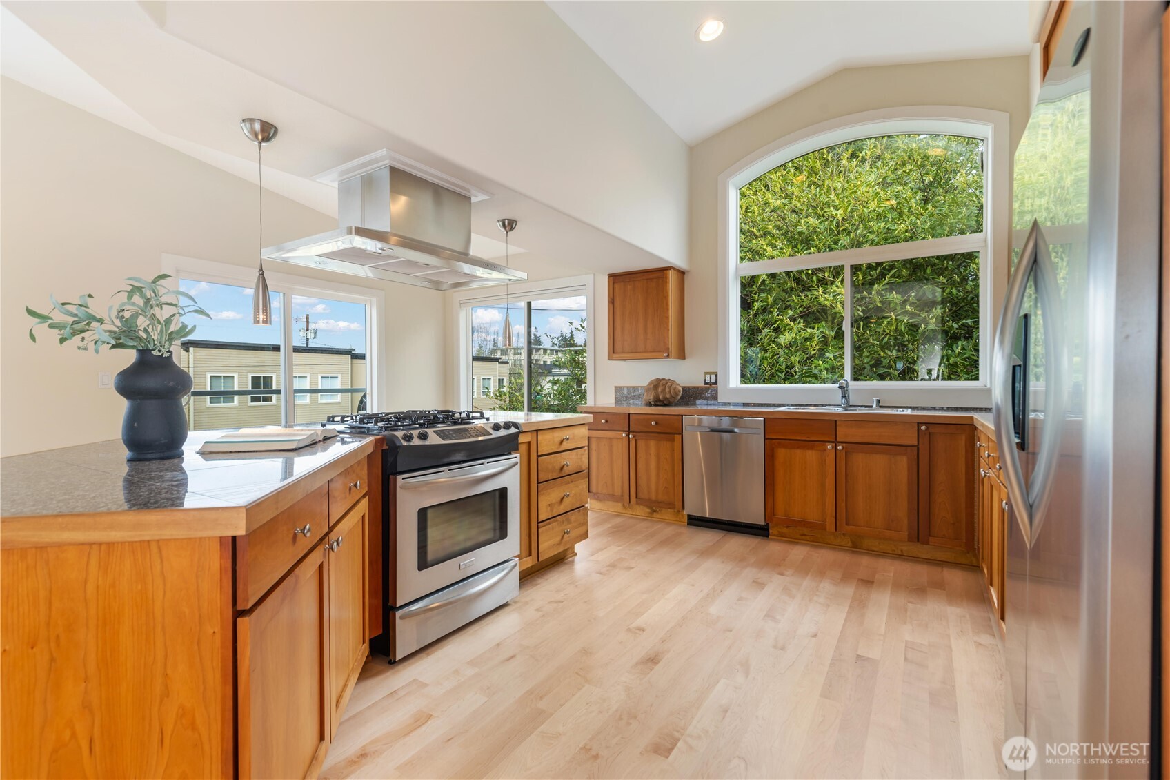 550 Dayton Street, Unit 201 Edmonds, WA 98020 - Photo 17 of 38 a kitchen with a sink cabinets stainless steel appliances and a large window